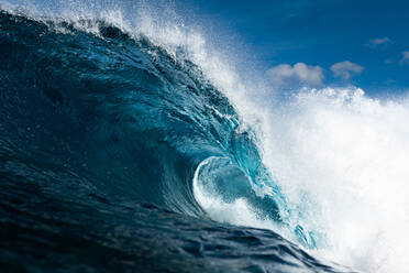 Powerful foamy sea waves rolling and splashing over water surface against cloudy blue sky - ADSF44384