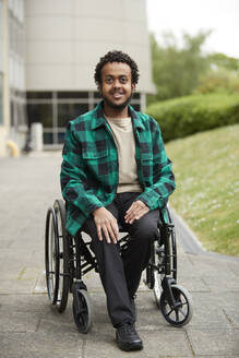 Portrait of smiling young man in wheelchair - ISF26081