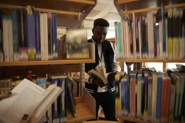 University students reading books in library - ISF26125
