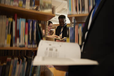 University students reading books in library - ISF26126