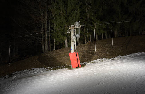 Ski lift on ski slope at night - ISF26251