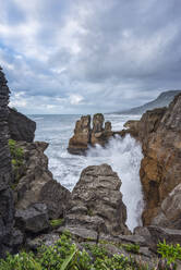 New Zealand, South Island New Zealand, Clouds over Pancake Rocks at Dolomite Point in Paparoa National Park - RUEF04091