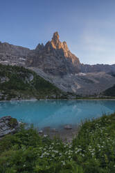 Italy, Veneto, Lake Sorapiss and Dito di Dio peak at springtime dusk - RUEF04109