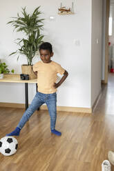 Boy playing with soccer ball at home - JCCMF10572