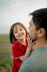 Happy boy having fun with father in field - ANAF01604