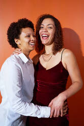 Portrait happy, beautiful lesbian couple laughing and hugging - CAIF33412