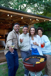 Portrait happy lesbian and gay male couple enjoying barbecue - CAIF33490