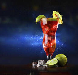 Singapore sling cocktail in tall glass against dark background - CAIF33623