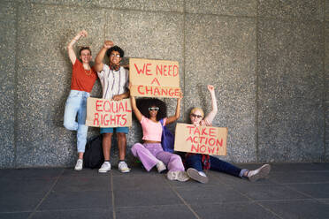 Portrait young protester friends holding equal rights signs - CAIF33701