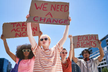 Young protester friends holding equal rights signs overhead - CAIF33705