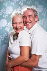 Portrait happy, carefree senior couple hugging - CAIF33837