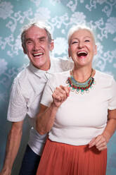 Portrait happy, carefree senior couple dancing - CAIF33838