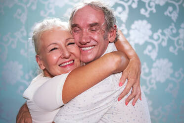 Close up portrait happy, affectionate senior couple hugging - CAIF33840