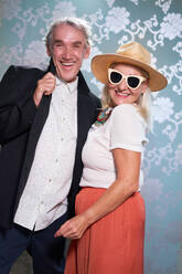 Portrait happy, playful, stylish senior couple - CAIF33841