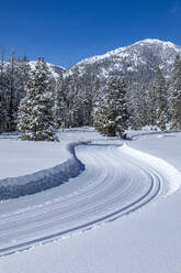 USA, Idaho, Sun Valley, Country road in mountains in winter - TETF02010