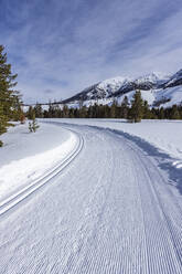 USA, Idaho, Sun Valley, Snow-covered mountains with dirt road - TETF02022