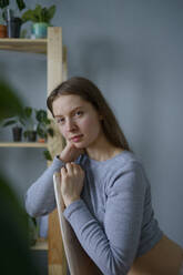 Portrait of woman looking at camera at home - TETF02042