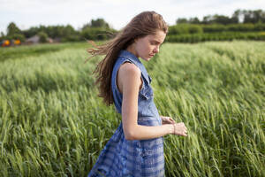 Portrait of woman standing in field - TETF02045