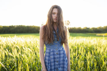 Portrait of woman standing in field - TETF02047