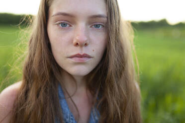 Portrait of woman standing in field - TETF02050