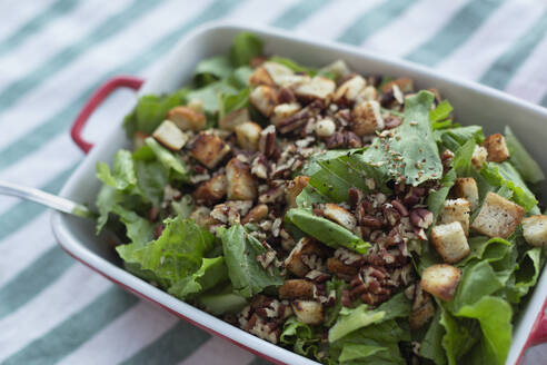 Still life close up healthy, fresh salad with walnuts and croutons - FSIF06318