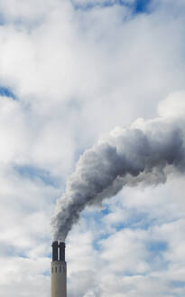 Smoke cloud emitting from factory smokestack into sky - FSIF06328