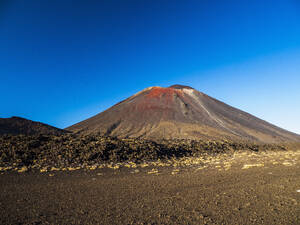 New Zealand, Waikato, Tongariro National Park, Mount Ngauruhoe volcano against blue sky - TETF02078