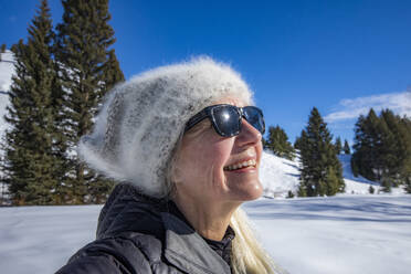 Smiling senior woman relaxing in mountains - TETF02103