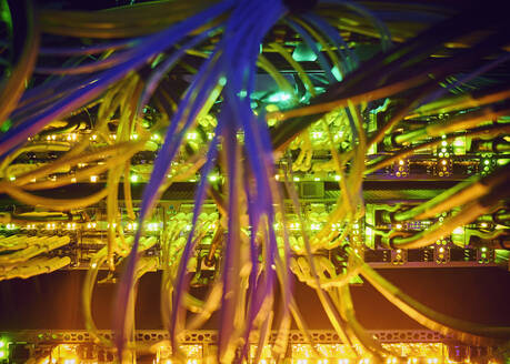 Close-up of tangled computer cables in server room - TETF02155