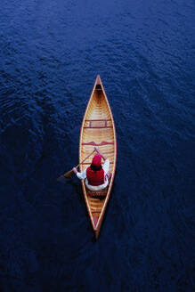 Overhead view of woman paddling canoe on Lake Placid - TETF02160