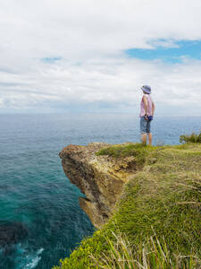 Australia, New South Wales, Port Macquarie, Woman standing on cliff and looking at view - TETF02175
