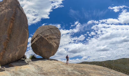 Australia, Queensland, Girraween National Park, Woman standing next to large rock during hike in wilderness - TETF02177