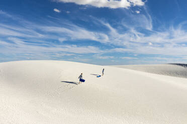 United States, New Mexico, White Sands National Park, People on dunes - TETF02187