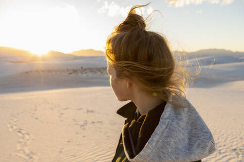 United States, New Mexico, White Sands National Park, Teenage girl looking at sunset - TETF02190