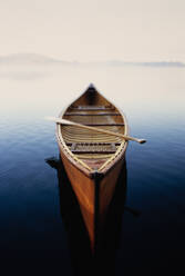 United States, New York, Canoe in morning mist on Lake Placid, Adirondacks State Park - TETF02204