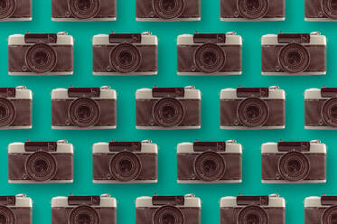 Background of assorted vintage photo cameras arranged in rows on blue surface with lens - ADSF44388