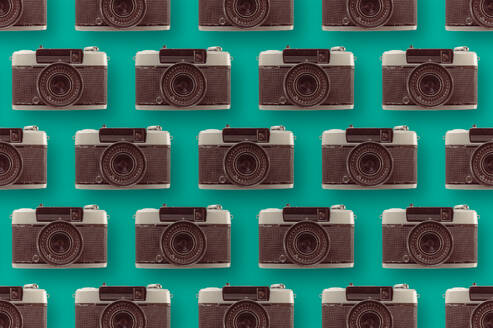 Background of assorted vintage photo cameras arranged in rows on blue surface with lens - ADSF44388