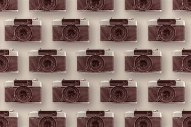 Background of assorted vintage photo cameras arranged in rows on bright surface with lens - ADSF44389