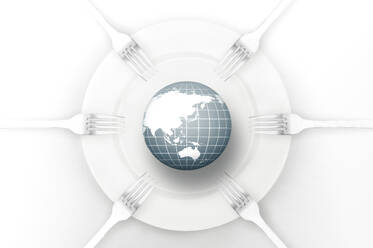 Earth globe placed on white round plate for food surrounded by forks against white background - ADSF44406