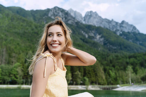 Beautiful woman enjoying nature in front of mountains - NDEF00919