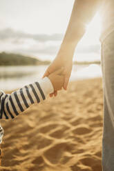 Mother and son holding hands at beach - ANAF01696