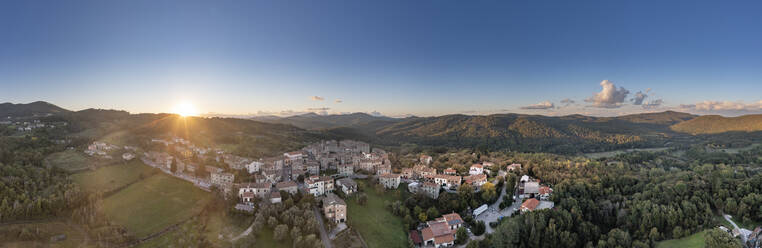 Italy, Tuscany, Torniella, Aerial panorama of mountain village at sunset - AMF09929