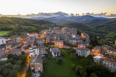 Italy, Tuscany, Torniella, Aerial view of mountain village at dusk - AMF09930