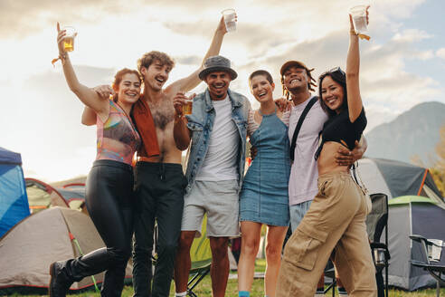 Group of young people comes together at a summer festival camp, embracing the spirit of celebration and enjoying a memorable time filled with fun and camaraderie. This photo has intentional use of 35mm film grain. - JLPPF02195