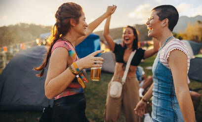 Fun moments unfold as three inseparable female friends come together in laughter, dance, and exuberant celebration, embracing the summer music festival's magical essence. This photo has intentional use of 35mm film grain. - JLPPF02270