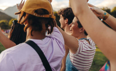 Crowd of excited music lovers comes together, celebrating unforgettable moments of pure elation and bliss at a captivating summer concert. This photo has intentional use of 35mm film grain. - JLPPF02281