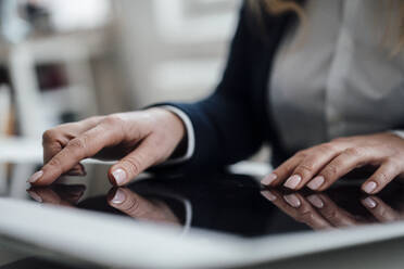 Businesswoman using graphics tablet in office - JOSEF19854