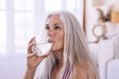 Mature woman drinking water at home - OIPF03214