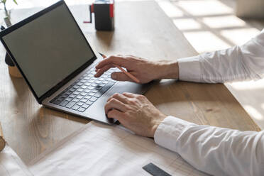 Hands of businessman typing on laptop at desk - VPIF08262