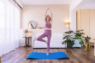 Fit Smiling Woman Practicing Tree Yoga Pose in Cozy Place Stock Photo -  Image of harmony, practicing: 286030458